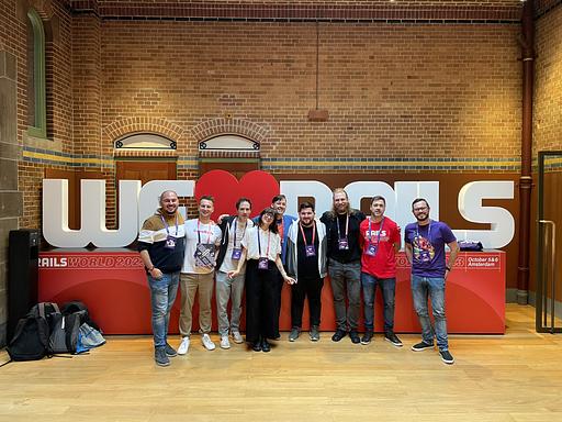 Ruby Conference Triathlon Crew - In front of the We Love Rails Sign